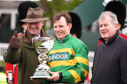 Jockey Paul Townsend (centre), trainer Willie Mullins (left) and owner of horse I Am Maximus, JP McManus celebrate with the trophy after victory in the Randox Grand National.