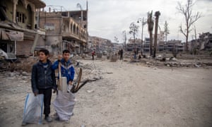 Boys scavenging for scrap metal in Raqqa
