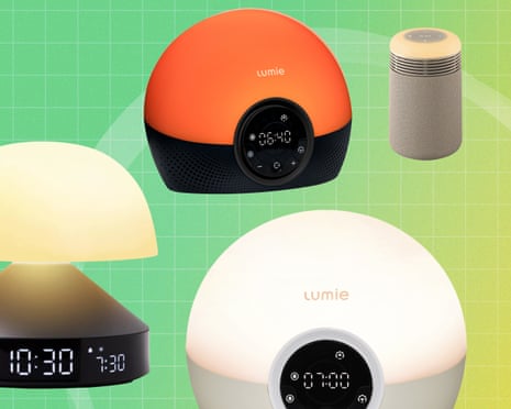 Four sunrise alarm clocks and lamps with glowing orange and warm white lights on a green background