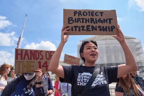 Hannah Liu, 26, of Washington, holds up a sign in support of birthright citizenship, in May 2025, outside the Supreme Court in Washington.