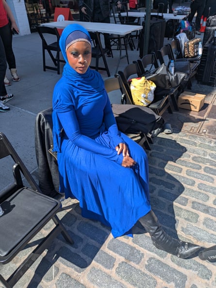 woman in blue outfit sits on chair outside