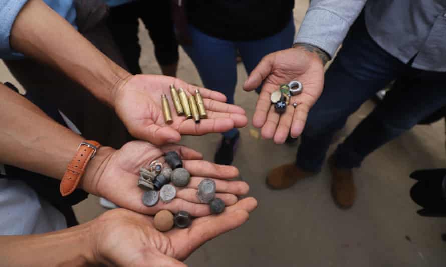 Protesters hold out bullet cartridges