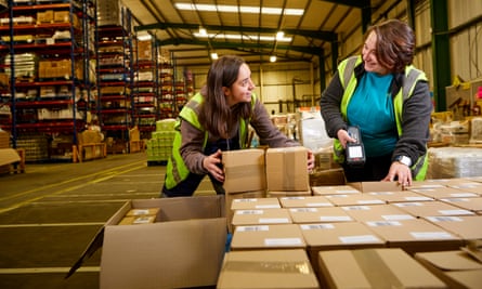 Jenny Carlyle (left) and Isis Carrasco scanning boxes in the Suma warehouse