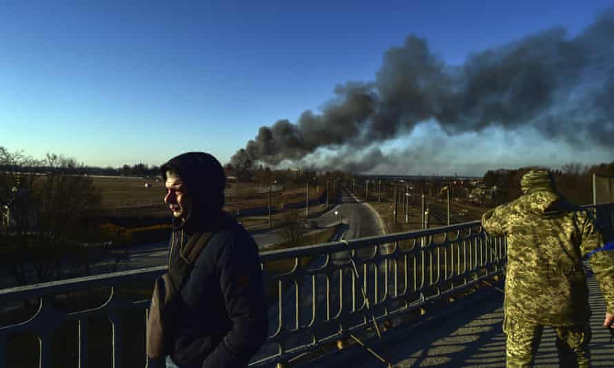Russian strikes on Lviv raise fears of Ukraine war spreading west | Ukraine 1 A Ukrainian soldier watches as a cloud of smoke rises after an explosion near the airport in Lviv on Friday.