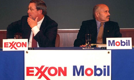 Lee Raymond, chairman of Exxon Corp., left, and Lucio Noto, chairman of Mobil Corp., look in opposite directions during the news conference to announce the merger of their companies Tuesday, Dec. 1, 1998, in New York .