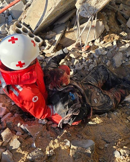 Photojournalist Zeinab Faraj being pulled out of the rubble by paramedics
