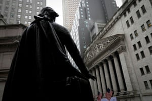 The New York stock exchange, seen from behind the statue of George Washington at Federal Hall