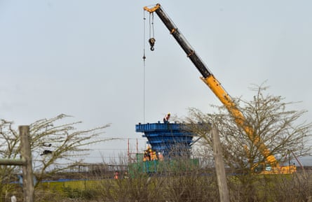 Construction labourers work on a pillar of the controversial railway line in the Nairobi national park.