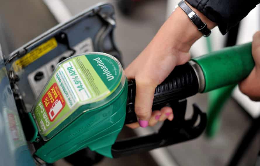 A person uses an Asda petrol pump in England