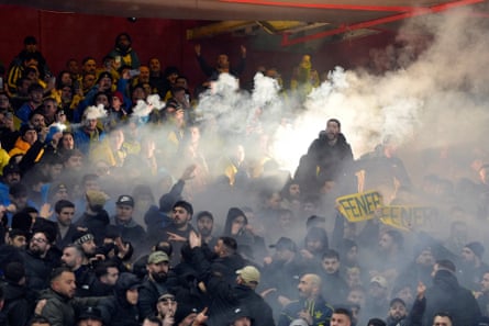 Fenerbahce fans threw flares on to the pitch and delayed the first half.