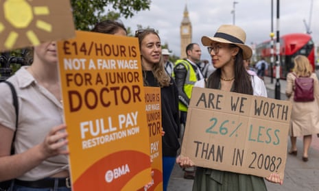 NHS workers picket outside St Thomas' hospital in London on Thursday during a five-day strike by junior doctors over pay and conditions.