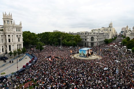 Aerial photograph of hundreds of people in a square