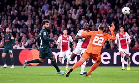 Mohamed Salah lifts the ball over Ajax goalkeeper Remko Pasveer to give Liverpool the lead
