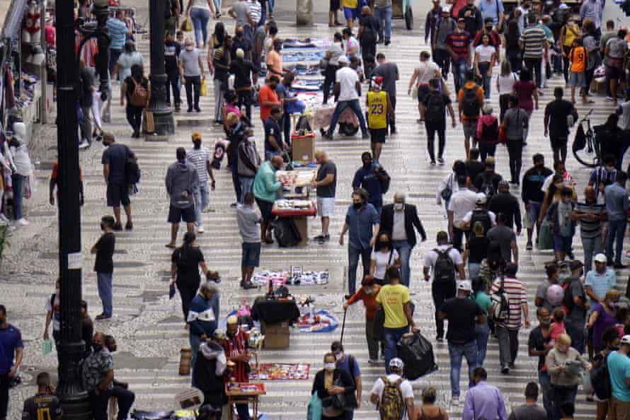 People walk in a shopping center in São Paulo, Brazil, on 4 March.