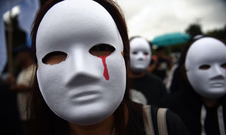 Protesters in Manila wear masks depicting victims of extra-judicial killings. The Philippines dropped the most places in the new Rule of Law Index.