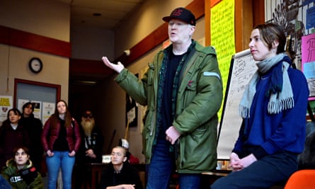 Garth Mullins (center), a podcast host and campaigner for decriminalization of drug possession, speaks alongside a lawyer, Caitlin Shane (right), at a meeting of the Vancouver Area Network of Drug Users (Vandu) to inform members of their rights under the new measures, 31 January 2023.