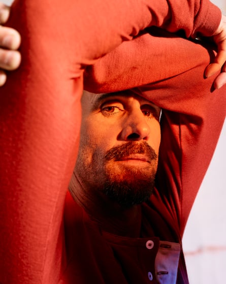Close-up of actor Joseph Fiennes with his arms around his head