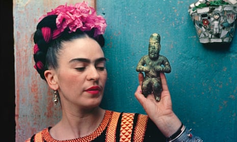 Frida Kahlo with an Olmec figurine in 1939.