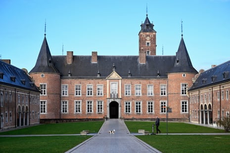 A man walks his dog inside the compound of the Alden Biesen castle.