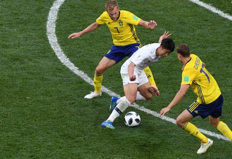 Son Heung-min attempts to get the better of Sweden’s Viktor Claesson , right, as he looks to get South Korea back in the game.