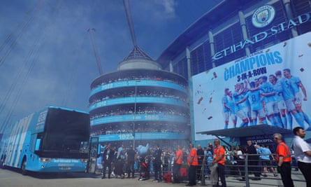 Manchester City fans greet the team bus during the Premier League title celebrations at the Etihad Stadium on Sunday.