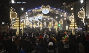 Bright lights and walking crowds at a Christmas market in Warsaw, Poland, on 5 December.