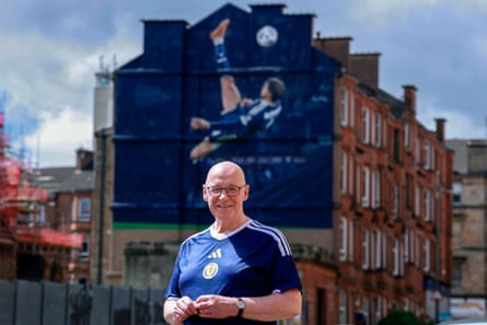 John Swinney in front of the Scott McTominay mural in Glasgow.