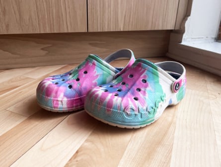 A pair of tie-dye fuzzy crocs