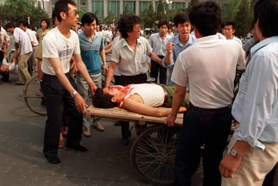 Local residents loaded two wounded people on a rickshaw flatbed shortly after PLA soldiers opened fire on a crowd in this June 4, 1989.