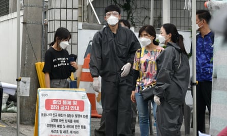 Government officials stand at a checkpoint to restrict access to the Sarang Jeil church in Seoul on 17 August.