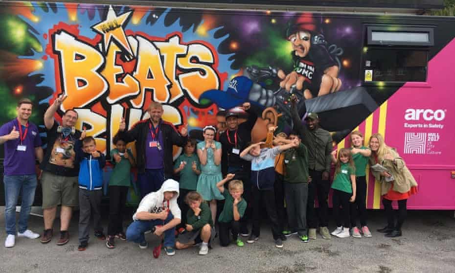 Adults and children in front of the Beats Bus in Hull