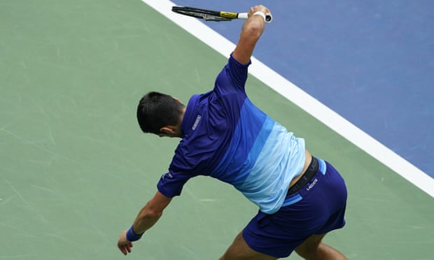 Novak Djokovic smashes his racket in frustration.