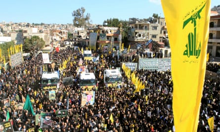 Four trucks surrounded by people