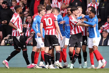 Keven Schlotterbeck of Southampton and Jayden Meghoma of Portsmouth clash