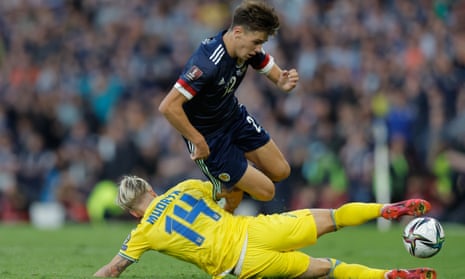Aaron Hickey tries to leap over a challenge by Ukraine’s Mykhaylo Mudryk during Scotland’s World Cup playoff last month.