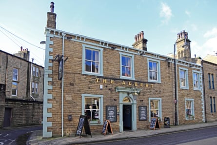 frontage of a traditional pub made of sandstone bricks