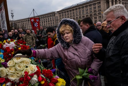A woman places flowers on the coffin of a young volunteer who was killed during a sabotage mission in the Russian providence of Bryansk – March 2023