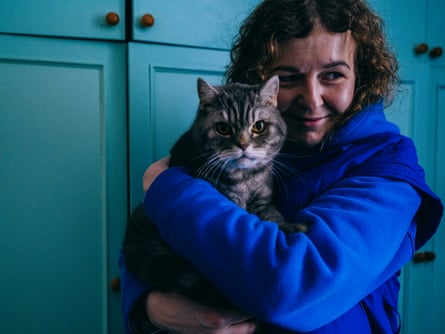 Julia Po hugging her cat