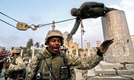 US Marines arrive to help Iraqi civilians pull down a statue of Saddam Hussein, in Baghdad, Iraq, 2003.
