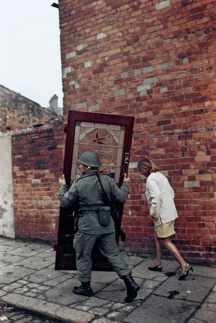 British soldier carrying a door, Bombay Street, west Belfast, 1969.