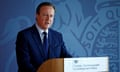 David Cameron stands at a podium