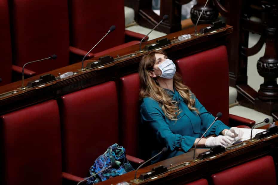 Maria Teresa Baldini of the far-right Fratelli d’Italia (Brothers of Italy) party wears a protective mask and gloves inside parliament after Italy’s lockdown.
