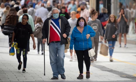 Two people in Cardiff wearing facemasks.