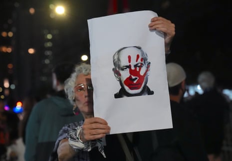 A pro-Palestinians protester holds up an image of Israel's prime minister, Benjamin Netanyahu, who is scheduled to address the UN general assembly amid growing international isolation for his country.
