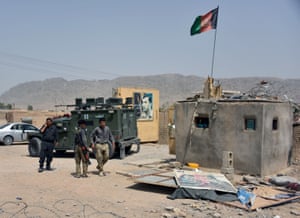 Afghan security forces inspect the site of a car bomb attack in Kandahar province on Tuesday