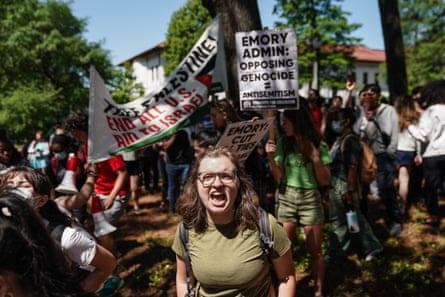 People yell and hold signs.