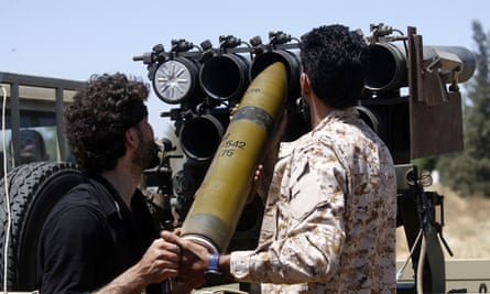 Fighters loyal to the UN-recognised Government of National Accord load a launcher during fighting south of Tripoli.