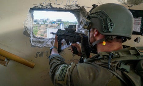 An Israeli soldier aims a weapon in Gaza