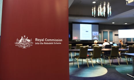 Banner that reads the royal commission into the robodebt scheme in front of chairs set up before a monitor