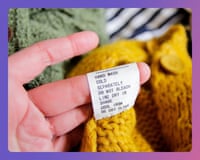 A hand holds a white care label with washing instructions attached to a yellow knitted garment.